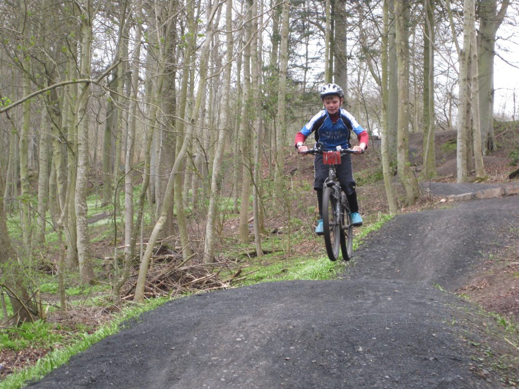 A cyclist jumping at Angraflat bike trail in Kelso.